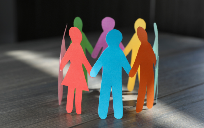 Values in your Biotech: image shows 8 paper men and women each in different colours standing in a circle holding hands.